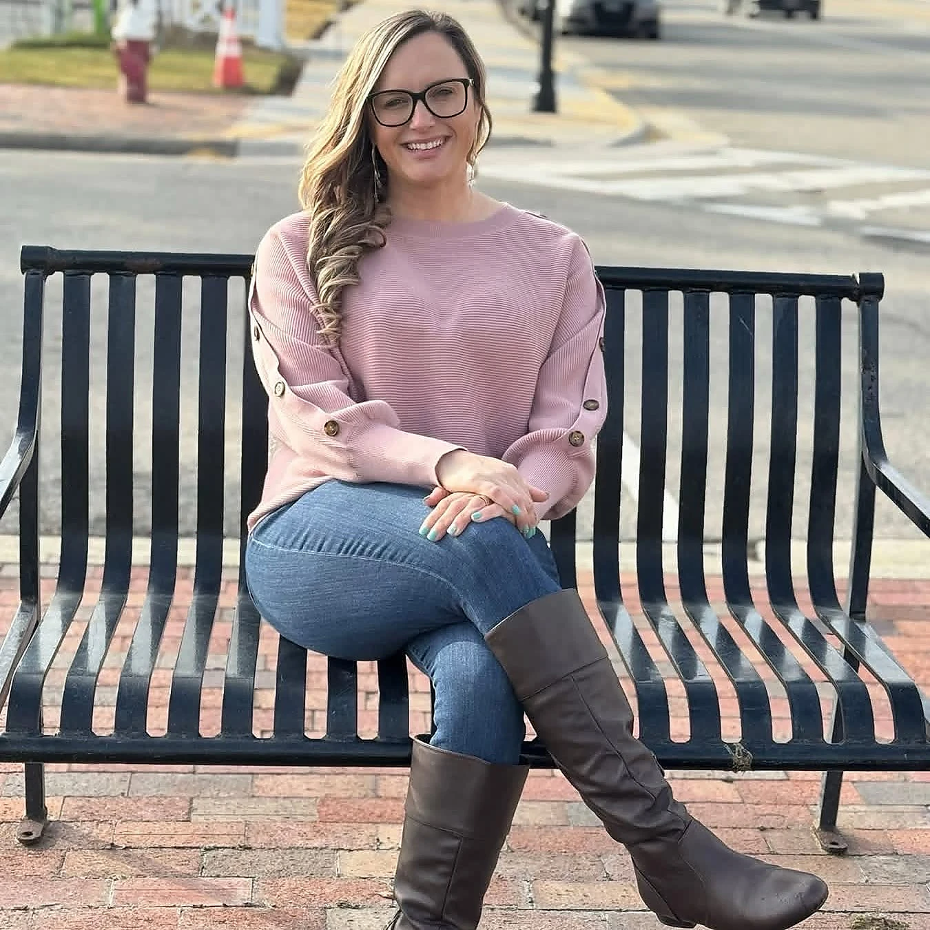 Amber Lee smiling on a bench in Elizabeth City